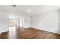 Spacious living room with hardwood floors, white walls, and ample natural light at 5449 Baybrook Cir, South Fulton, GA 30349