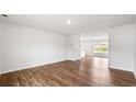 Bright living room with hardwood floors, white walls, and ample natural light from a window at 5449 Baybrook Cir, South Fulton, GA 30349