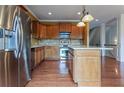 A spacious kitchen features an island, stainless steel appliances, and hardwood floors at 275 Autry Mill Ln, Suwanee, GA 30024