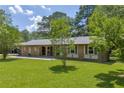 A charming single-story brick house sitting on a well-manicured lawn with mature trees at 676 Smith Store Rd, Covington, GA 30016