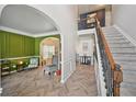 Inviting foyer with herringbone floors, soaring ceilings, and archways leading to other rooms at 7530 Springbox Dr, Fairburn, GA 30213