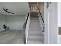 Inviting entryway featuring gray floors, stairs with black trim, and abundant natural light at 128 Evergreen Trl # 4, Cartersville, GA 30121