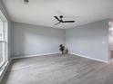 Bright living room with gray floors, a modern ceiling fan, and neutral paint that create a calming ambiance at 128 Evergreen Trl # 4, Cartersville, GA 30121