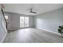 Open-concept living room with gray floors, stairs, large window that fills the space with natural light at 128 Evergreen Trl # 4, Cartersville, GA 30121