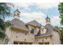 Close-up of the home's turret, showcasing architectural details like the cupola and shingle roof at 165 Ansley Way, Roswell, GA 30075