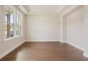 Bright living room with large windows, hardwood floors and tray ceiling at 2545 Bertrand Way, Cumming, GA 30041