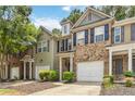 Two-story townhome showcasing brick and vinyl siding, black shutters, and well-maintained front yard at 3335 Thornbridge Dr, Powder Springs, GA 30127