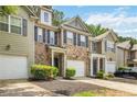 Charming two-story townhome with brick facade, black shutters, one-car garage, and manicured shrubs at 3335 Thornbridge Dr, Powder Springs, GA 30127
