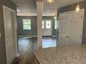 Bright living room with stylish lighting, neutral gray paint, wood trim and beautiful laminate flooring at 5090 Lorraine Pl, Forest Park, GA 30297