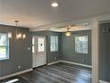 Bright living room with stylish lighting, neutral gray paint, wood trim and beautiful laminate flooring at 5090 Lorraine Pl, Forest Park, GA 30297