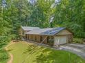 Charming brick home with arched windows, lush lawn, and surrounded by mature trees at 5632 Stillwater Ct, Stone Mountain, GA 30087
