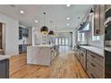 Gourmet kitchen featuring a large waterfall island, stainless appliances, and sleek cabinets at 1240 Hayes Sq, Peachtree City, GA 30269