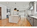 Modern kitchen features stainless appliances, gas range, and large island with seating at 1240 Hayes Sq, Peachtree City, GA 30269