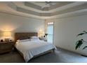 A brightly lit and spacious main bedroom with a queen-size bed, neutral walls, and a large window at 2612 Peterboro Row, Marietta, GA 30062