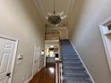 Bright foyer featuring a staircase with a decorative chandelier and a view of the living room at 2612 Peterboro Row, Marietta, GA 30062