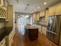 Spacious kitchen with a granite island, stainless appliances, custom cabinets, and wood floors at 2612 Peterboro Row, Marietta, GA 30062