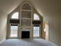Bright and airy living room with a vaulted ceiling, fireplace, and large windows with views at 2612 Peterboro Row, Marietta, GA 30062