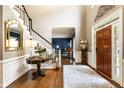 Elegant foyer with hardwood floors, staircase, and decorative table, creating a grand entrance at 10530 Tuxford Dr, Alpharetta, GA 30022