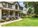 Landscaped front yard and inviting porch of this home create a warm and welcoming atmosphere at 10530 Tuxford Dr, Alpharetta, GA 30022