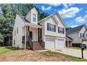 Charming two-story home with a two-car garage and inviting front porch with decorative columns at 2169 Wingfoot Pl, Decatur, GA 30035