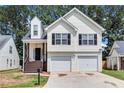 Charming two-story home with a two-car garage and inviting front porch with decorative columns at 2169 Wingfoot Pl, Decatur, GA 30035