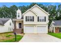Charming two-story home boasts a two-car garage, inviting staircase, and neatly maintained front yard at 2169 Wingfoot Pl, Decatur, GA 30035