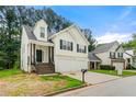 Charming two-story home boasts an attached two-car garage, and a stairway leading up to the front door at 2169 Wingfoot Pl, Decatur, GA 30035
