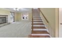 Bright living room with fireplace and staircase at 405 W Leslie Ct, Woodstock, GA 30188