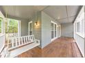 Relax on the spacious porch with a swing and views of the lush surroundings at 405 W Leslie Ct, Woodstock, GA 30188