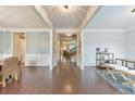Elegant hallway with wood floors, white trim, and an open view to the living spaces and staircase at 456 Rockford Sw Pass, Marietta, GA 30064