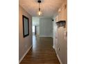 Inviting entryway featuring wood-look flooring and modern light fixtures with a view into the living space at 804 Village Pl, Loganville, GA 30052