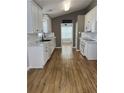 Bright kitchen featuring white cabinets, stainless appliances, and a view into the breakfast nook at 804 Village Pl, Loganville, GA 30052