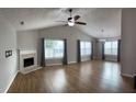 Bright living room with vaulted ceilings, fireplace, wood floors, and ample natural light at 804 Village Pl, Loganville, GA 30052