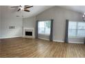 Open living room featuring wood floors, fireplace, and lots of natural light at 804 Village Pl, Loganville, GA 30052