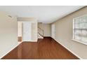 Spacious living room with hardwood floors, two entry doors, and a staircase to the upper level at 4701 Flat Shoals Road Rd # 37H, Union City, GA 30291