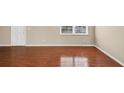 Bright living room featuring neutral paint, hardwood floors, and a window for natural light at 4701 Flat Shoals Road Rd # 37H, Union City, GA 30291