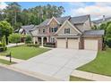 Spacious brick home featuring a three-car garage and an expansive driveway at 508 Highland Dr, Woodstock, GA 30188