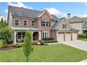 Beautiful home boasts manicured lawn and a three-car garage, enhancing its curb appeal at 508 Highland Drive Dr, Woodstock, GA 30188