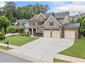 Stunning home with well-kept lawn, three-car garage, and lush greenery creating an inviting outdoor space at 508 Highland Drive Dr, Woodstock, GA 30188