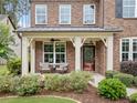 Charming front porch area with comfortable seating, perfect for relaxing outdoors at 508 Highland Drive Dr, Woodstock, GA 30188