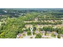 Aerial view showcases the home's location nestled among lush greenery in a peaceful neighborhood setting at 726 Sunset Ridge Ln, Lawrenceville, GA 30045