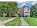 Charming two-story home with well-maintained lawn, mature trees, and a welcoming walkway at 2803 Snapfinger Manor Mnr, Decatur, GA 30035