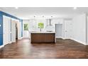 This stunning kitchen features a large center island, stainless steel appliances and dark woodgrain floors at 38 Creek Se Dr, Cartersville, GA 30121