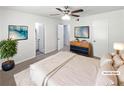 Well-staged bedroom with a comfortable bed, modern decor, a ceiling fan, and natural light, creating a relaxing atmosphere at 978 Monopoly Dr, Lawrenceville, GA 30046