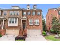 Charming brick townhome with a well-maintained lawn and convenient attached two-car garage at 2428 Hadlow Ln # 25, Atlanta, GA 30339