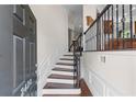 Inviting entryway features hardwood floors, elegant wainscoting, and a staircase with iron balusters at 2428 Hadlow Ln # 25, Atlanta, GA 30339