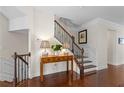 Lovely foyer featuring hardwood floors, a staircase with iron railing and decorative console table at 2428 Hadlow Ln # 25, Atlanta, GA 30339