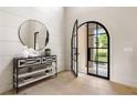 Bright foyer with stylish console table, decorative mirror, and open view through arched front door to the exterior at 2609 Dogwood Terrace Ne, Atlanta, GA 30319