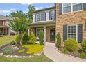 Inviting front entrance with stone facade, columns, and manicured landscaping at 3420 Pleasant Springs Dr, Cumming, GA 30028