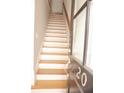 A view of the home's staircase featuring wood treads and a sleek handrail at 3541 Roswell Ne Rd # 20, Atlanta, GA 30305
